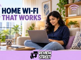 Woman using a laptop near a home Wi-Fi router, with ReviewStreet branding.